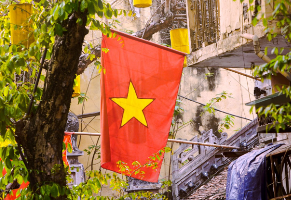 vietnam flag hanging on the side of a building