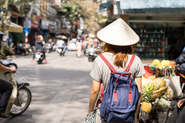 a woman walking around the streets of Vietnam